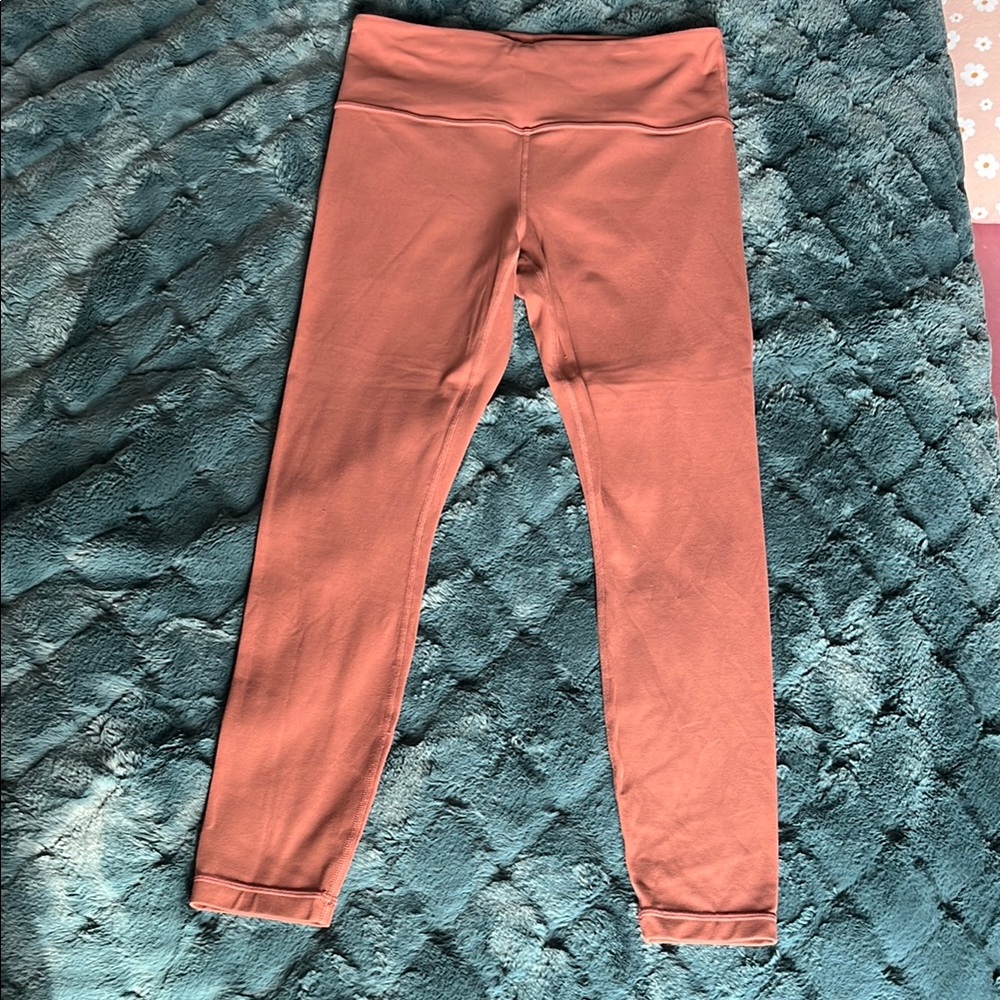 Athleta Burnt Orange Salutation Leggings size Small